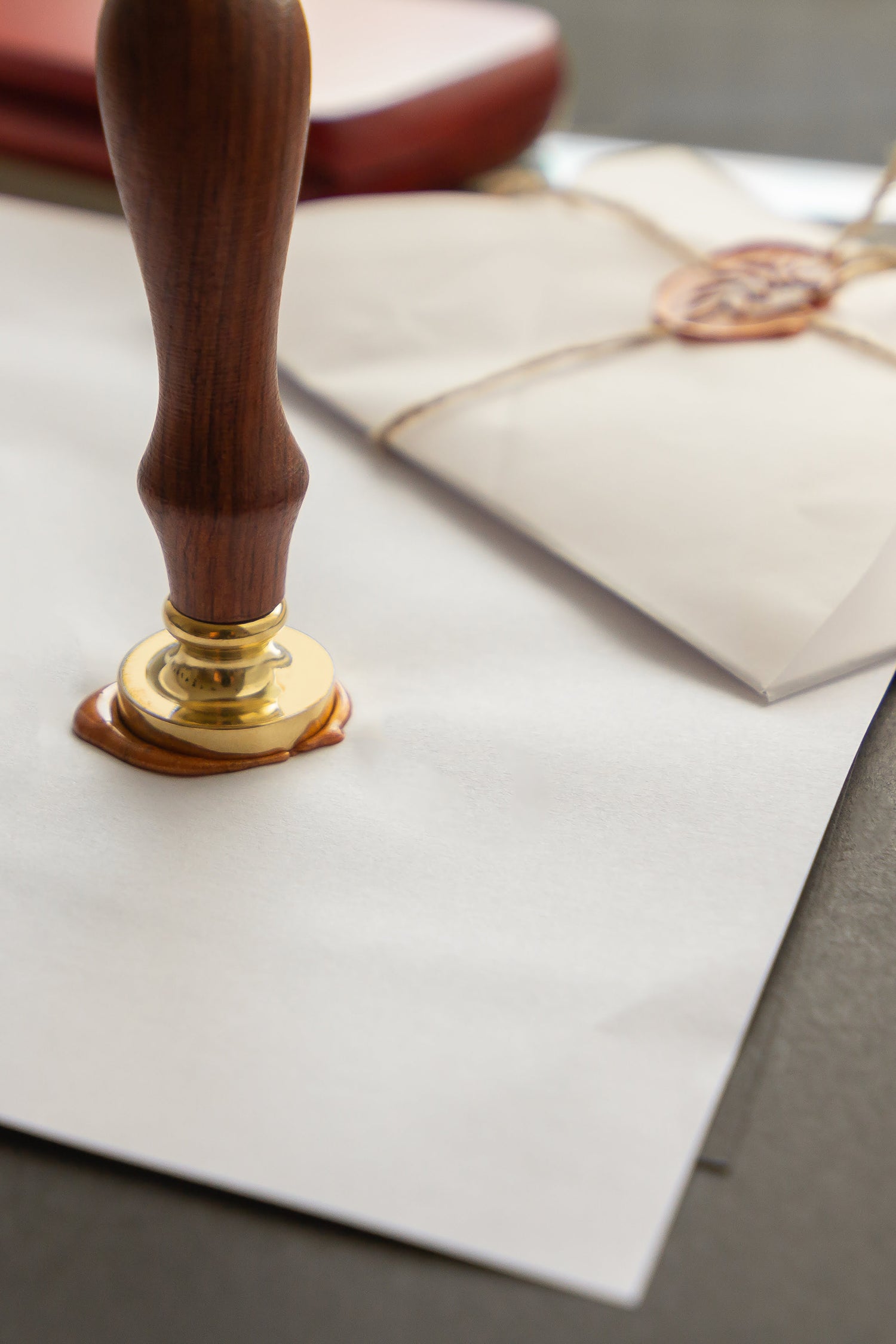 Wax seal stamp on a letter with a gold wax seal
