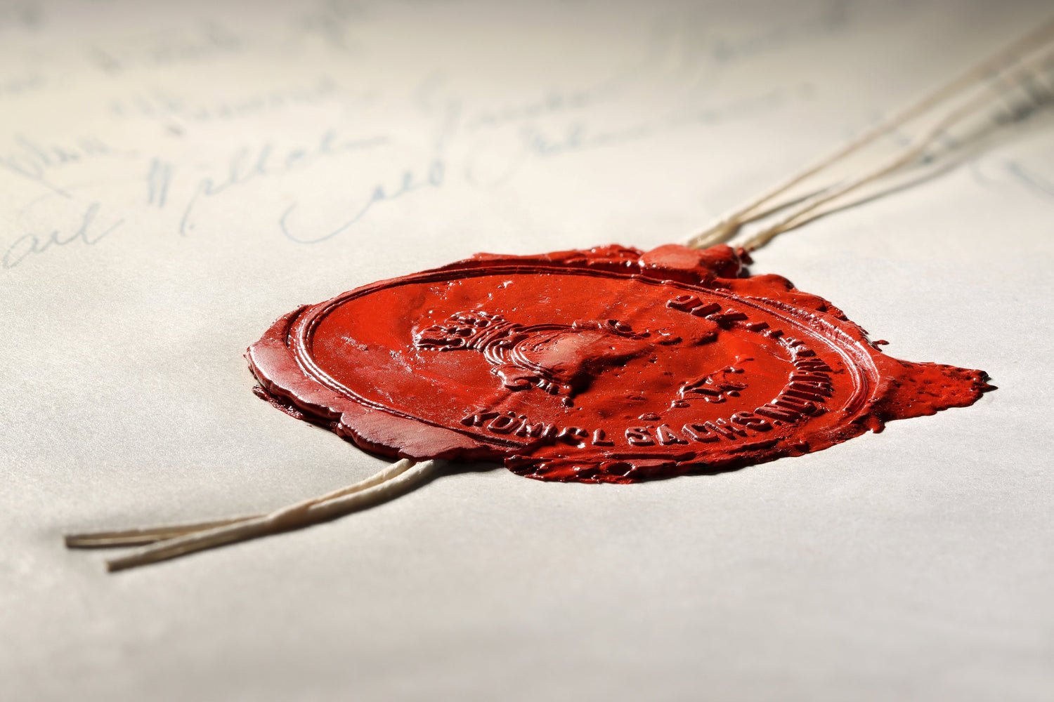 Red wax seal on a document with visible text